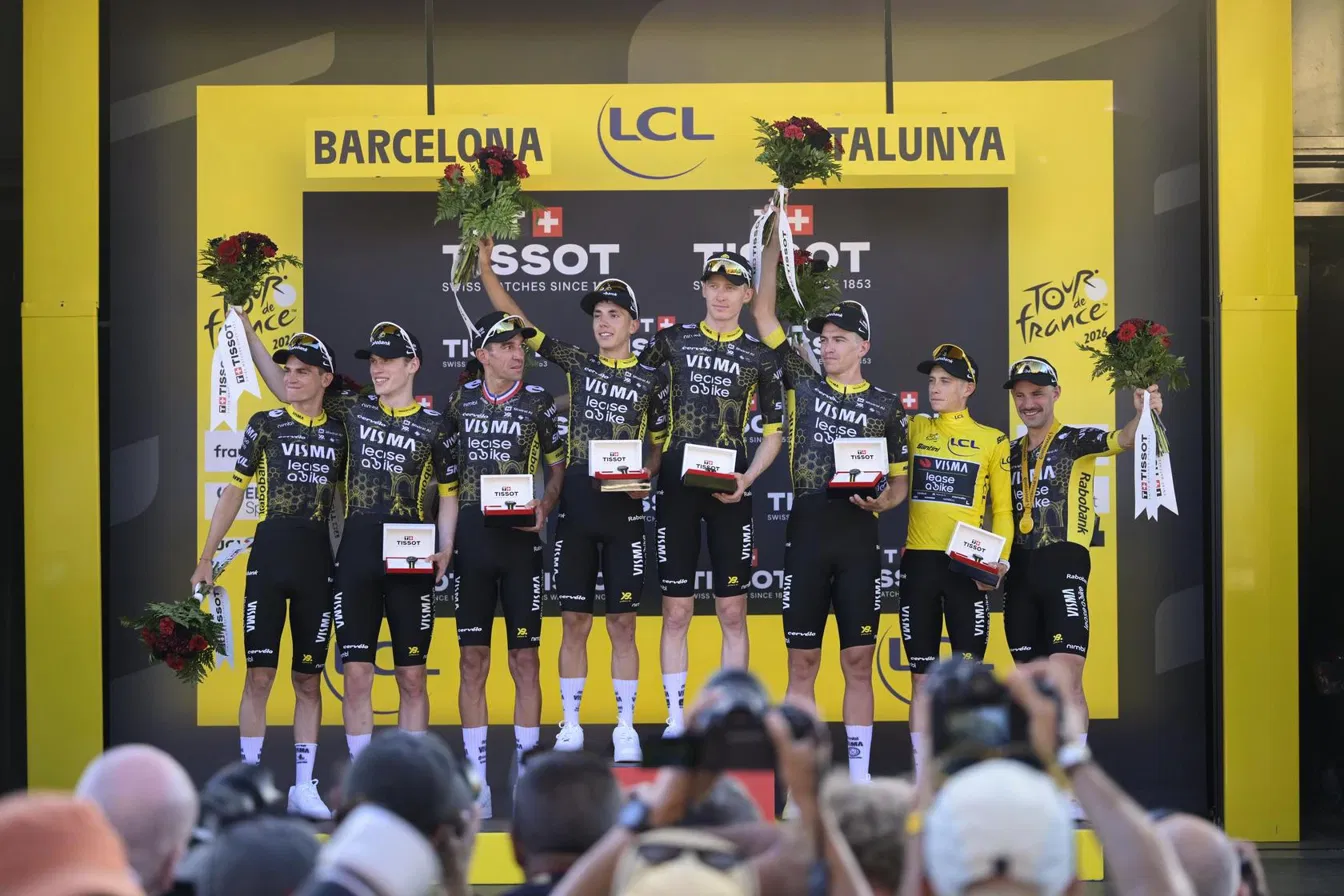 Team Visma-Lease a Bike celebrate their opening team time trial victory on the podium in Barcelona